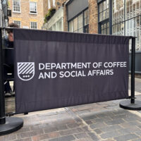 Black cafe posts with fabric barrier graphic